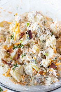 potato salad with bacon and cheese in a glass bowl