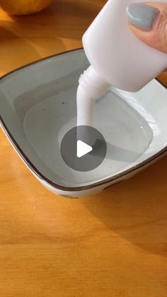 a person is pouring milk into a bowl