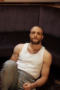 a man sitting on the floor in front of a couch