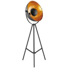 an orange and black lamp on a tripod stand