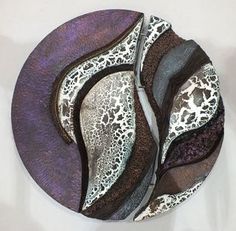 a purple and black plate with an animal print design on the side, sitting on a white surface