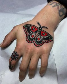 a woman's hand with a butterfly tattoo on it