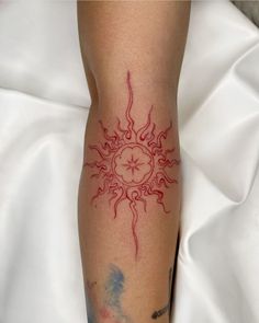 a woman's leg with a tattoo on it and the sun in the middle