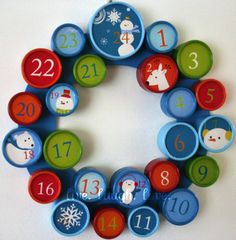 a christmas wreath made out of magnets with numbers and snowmen on the front