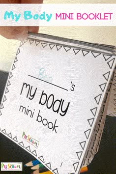 someone is holding up a mini book with the words my body in it