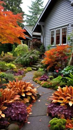 a house with lots of trees and flowers in the front yard