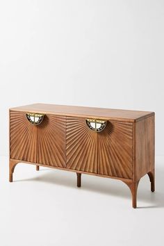 an art deco sideboard with two brass knobs