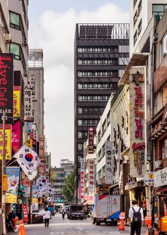 a city street filled with lots of tall buildings