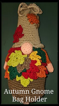 a crocheted bag with flowers on it and the words autumn gnomee bag holder