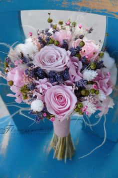 a bouquet of flowers sitting on top of a blue chair