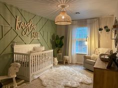 a baby's room decorated in green and white