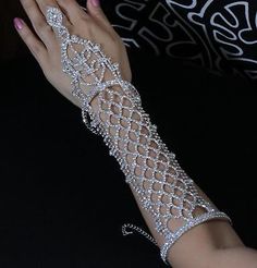 You are looking at a gorgeous Austrian rhinestone long slave glove/ bracelet with ring. This piece is perfect for wedding, party or any special occasions. Rhinestone design: 12"L X 2-3/8"W. Bracelet and ring band are both adjustable to fit most sizes. Prom Jewerly, Crystal Outfits, Diamond Gloves, Crystal Gloves, Rhinestone Gloves, Bracelet With Ring, Silver Gloves, Beaded Gloves, Long Bracelet