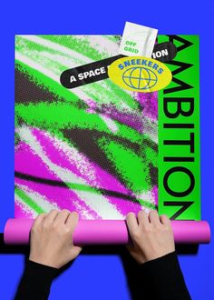 someone holding up a piece of art with the word expedition written on it in green, pink and blue