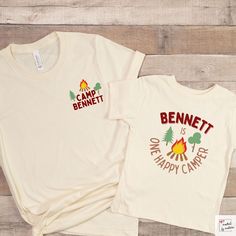 two t - shirts that say camp bennet and one is happy camper on them