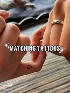 two people holding hands with tattoos on their fingers and the words matching tattoos above them