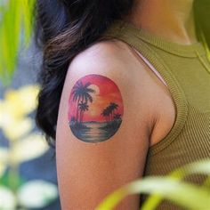 a woman with a palm tree tattoo on her arm