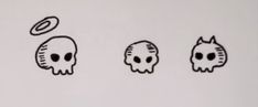 three skulls with different shapes and sizes are depicted on a white wall, one has an object in the middle