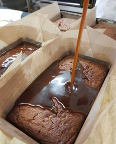 there is a chocolate cake in the box and it has been drizzled with brown liquid