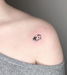 a ladybug tattoo on the shoulder