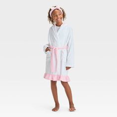 Your kid will be ready to wind down for bed in cozy style with this FAO Schwarz Hooded Robe with Headband. This white robe features a hooded design with a pink belt tie and ruffled hem, and it comes with a matching pink headband with a bow for a cute look. Made from soft knit fabric, this long-sleeve robe will be their new go-to pick for sleeping or lounging around the house. White Hooded Sleepwear For Loungewear, Hooded White Sleepwear For Sleepover, White Hooded Sleepwear For Sleepovers, Cozy White Hooded Sleepwear, White Cozy Sleep Robe, Cozy White Sleep Robe, White Winter Sleep Robe, Spring White Robe For Bedtime, White Spring Bedtime Robe