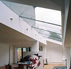 a living room filled with furniture and a large painting on the wall next to it