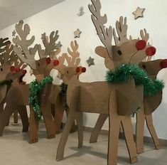 several cardboard reindeers are lined up against a wall