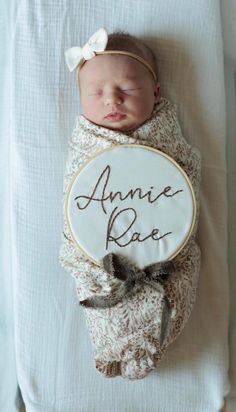 a baby wrapped in a blanket with the name annie rae on it