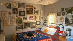 a bed room with a neatly made bed and lots of pictures on the wall