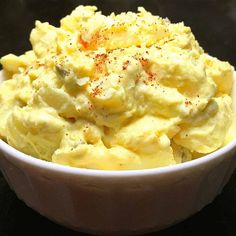 a white bowl filled with mashed potatoes on top of a table