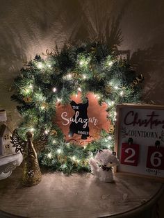 a christmas wreath and teddy bear are on a table in front of a sign that says the salvation