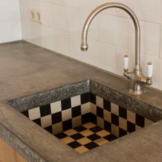 a kitchen sink with a checkerboard design in the middle