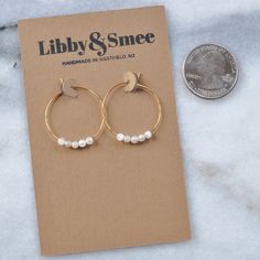 "You asked for it -- a tiny version of our semi-precious hoops. Available in a choice of energy-lifting gemstones, it's no wonder they've become a Libby & Smee favorite. Bonus: Moonstone is said to increase feminine energy, fertility, and sensuality! Your inner goddess will thank you. + 25mm (about 1\") gold-plated or silver-plated hoops with 3mm Moonstone beads + packaged on a hand-stamped kraft earring card in a clear resealing bag making them ready for gift giving. Additional gift wrap is ava Increase Feminine Energy, Tiny Gold Hoop Earrings, Earrings Small Hoop, Gemstone Hoop Earrings, Earring Card, Long Tassel Earrings, Tassel Jewelry, Moonstone Beads, Moonstone Earrings