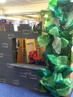 there is a cardboard castle made to look like it has leaves on it