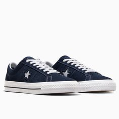 Style No. A04154C Color: Navy/White/Black In 1974, Converse launched a low-cut, suede version of the Chuck Taylor All Star, featuring a single star logo on one side—the One Star sneaker. Reissued in the early '90s, the design gained traction with the skateboarding community thanks to a performance remodel. Today's One Star Pro provides better boardfeel and impact protection thanks to a CONS traction rubber outsole and molded CX sockliner. The low profile adds total flexibility, while a rubber-ba Converse One Star Pro, Navy Converse, Red Puffer, Pretty Shoes Sneakers, Vintage Michigan, Red Converse, Converse One Star, Star Logo, Early 90s