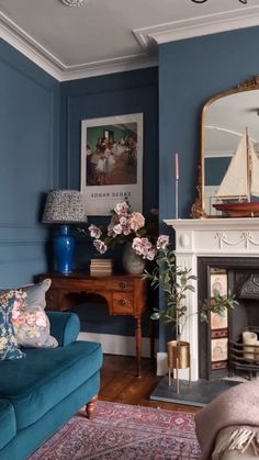 a living room filled with furniture and a fire place under a painting on the wall