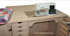 a sewing machine sitting on top of a wooden counter next to drawers and cabinets with other items