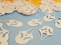 paper cut masks are arranged on a table