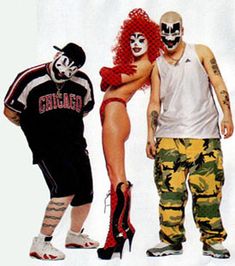 three people in costume standing next to each other with one person wearing a clown mask