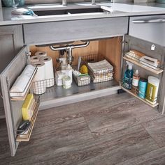 an open cabinet in the middle of a kitchen