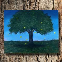 a painting of a tree with fireflies on it's leaves is hanging on the bark of a tree