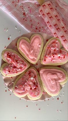 heart shaped cookies with pink icing and sprinkles