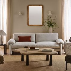 a living room filled with furniture and a mirror