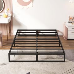 a metal bed frame in a bedroom with pink walls and white carpeted flooring