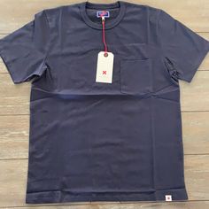 Best Made Co Standard Pocket-Tee , T-Shirt Navy Measurements: M- 20.5in W / 27in L L- 22in W / 28in L Made In Peru 100% Cotton Navy Crew Neck T-shirt For Summer, Blue Crew Neck T-shirt With Pockets, Navy Pre-shrunk Cotton T-shirt, Classic Blue Crew Neck T-shirt, Classic Blue T-shirt For Streetwear, Solid Color Short Sleeve T-shirt With Pockets, Graphic Tee Short Sleeve T-shirt With Pockets, Basic Short Sleeve T-shirt With Pockets, Branded Blue Summer Tops