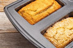 three trays with different types of bread in them on a wooden table, top view