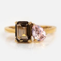 an engagement ring with two different colored stones