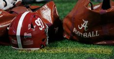 football helmets and bags sitting on the grass