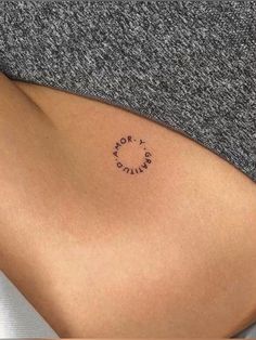 a woman's stomach with the word love written on it and a circle in the middle