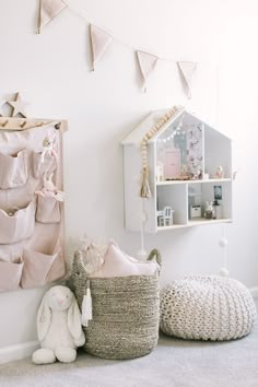 a baby's room with pink and white decor