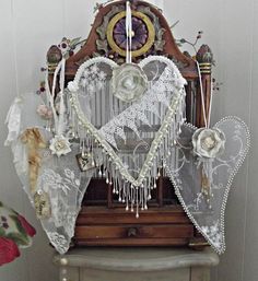 an old fashioned clock decorated with lace and flowers